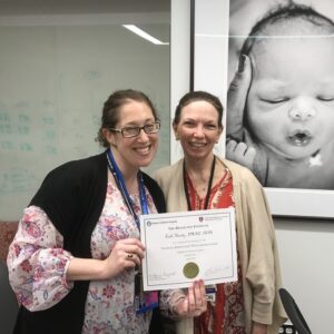 Dr. Lise Johnson giving a woman an award