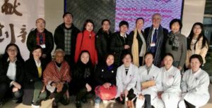 Eighteen men and women in two rows