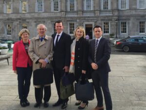 Three men and two woman outside a buidling