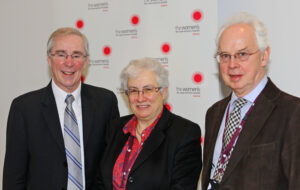 Two men and a woman smiling