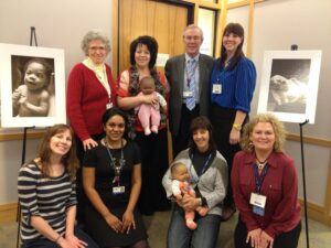 Dr. Kevin Nugent with seven women and two baby dolls