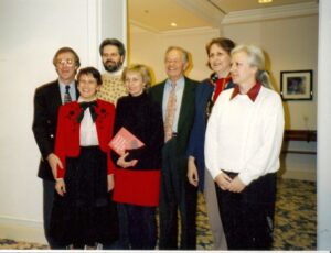Three men and four women in a doorway