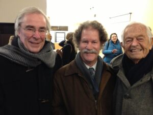 Three men wearing winter coats