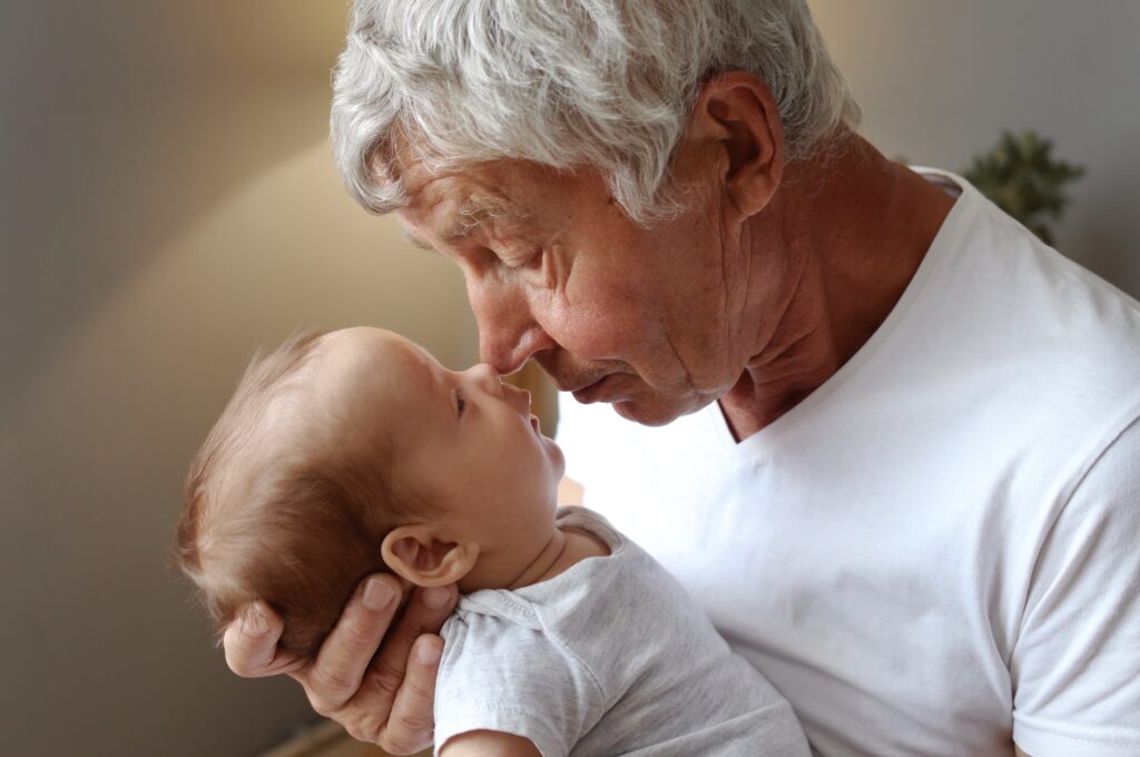 Older man holding a baby