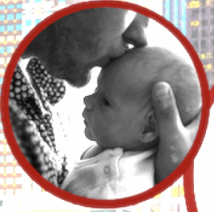 Man holding baby and kissing its forehead
